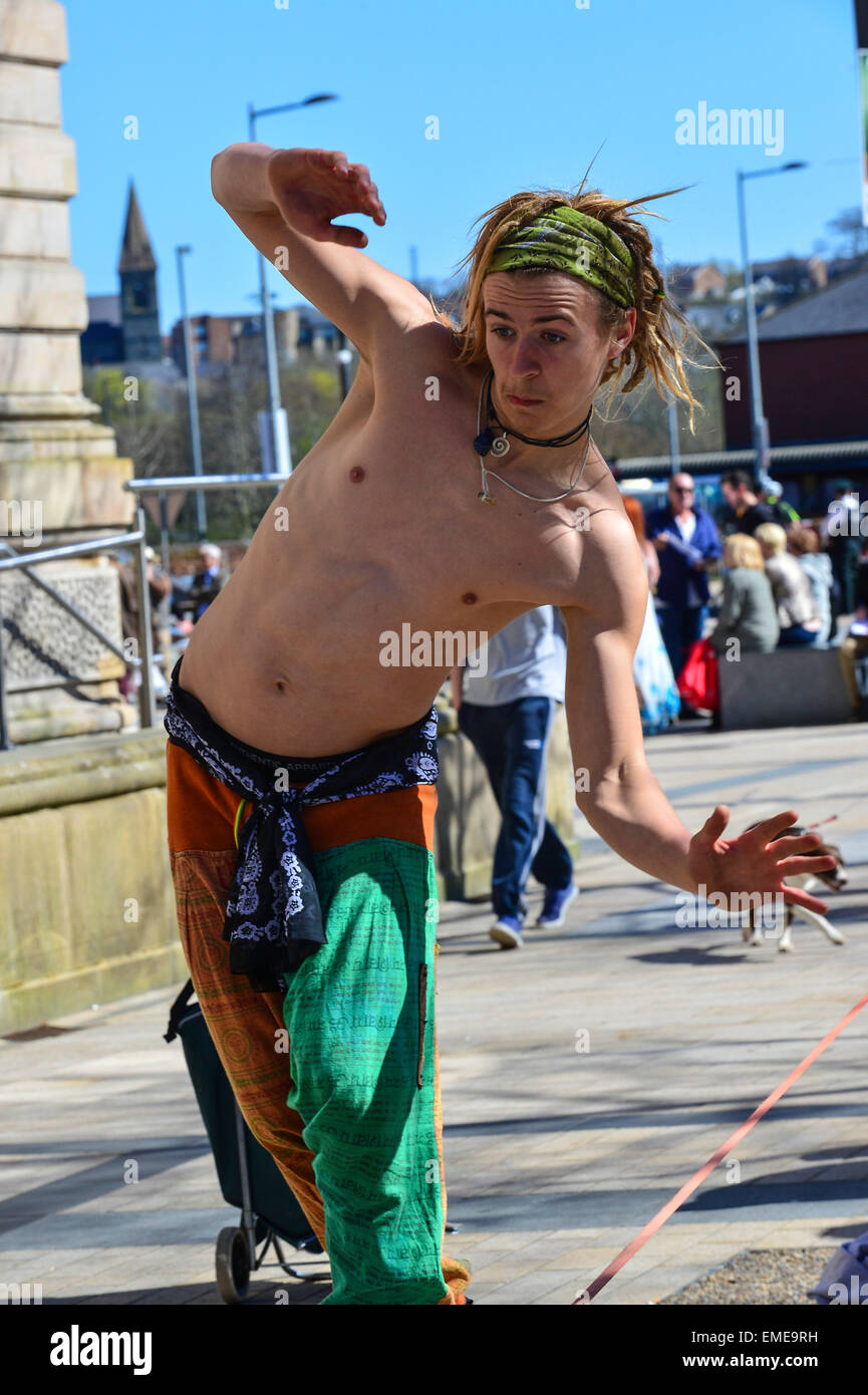 Young street entertainer performs tightrope act in Guildhall Square, Londonderry (Derry), Northern Ireland Stock Photo