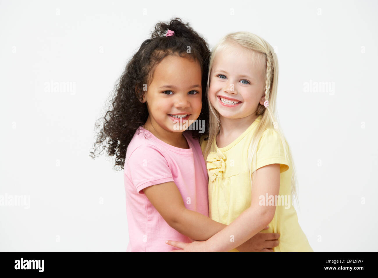 Two Pre School Girls Hugging One Another Stock Photo