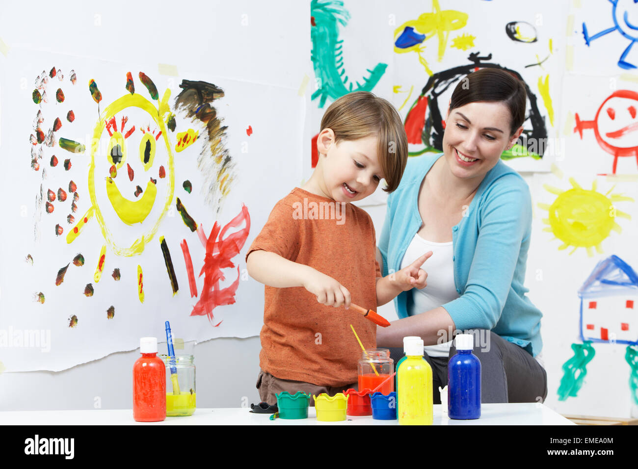 Teacher And Pupil In Pre School Art Class Stock Photo