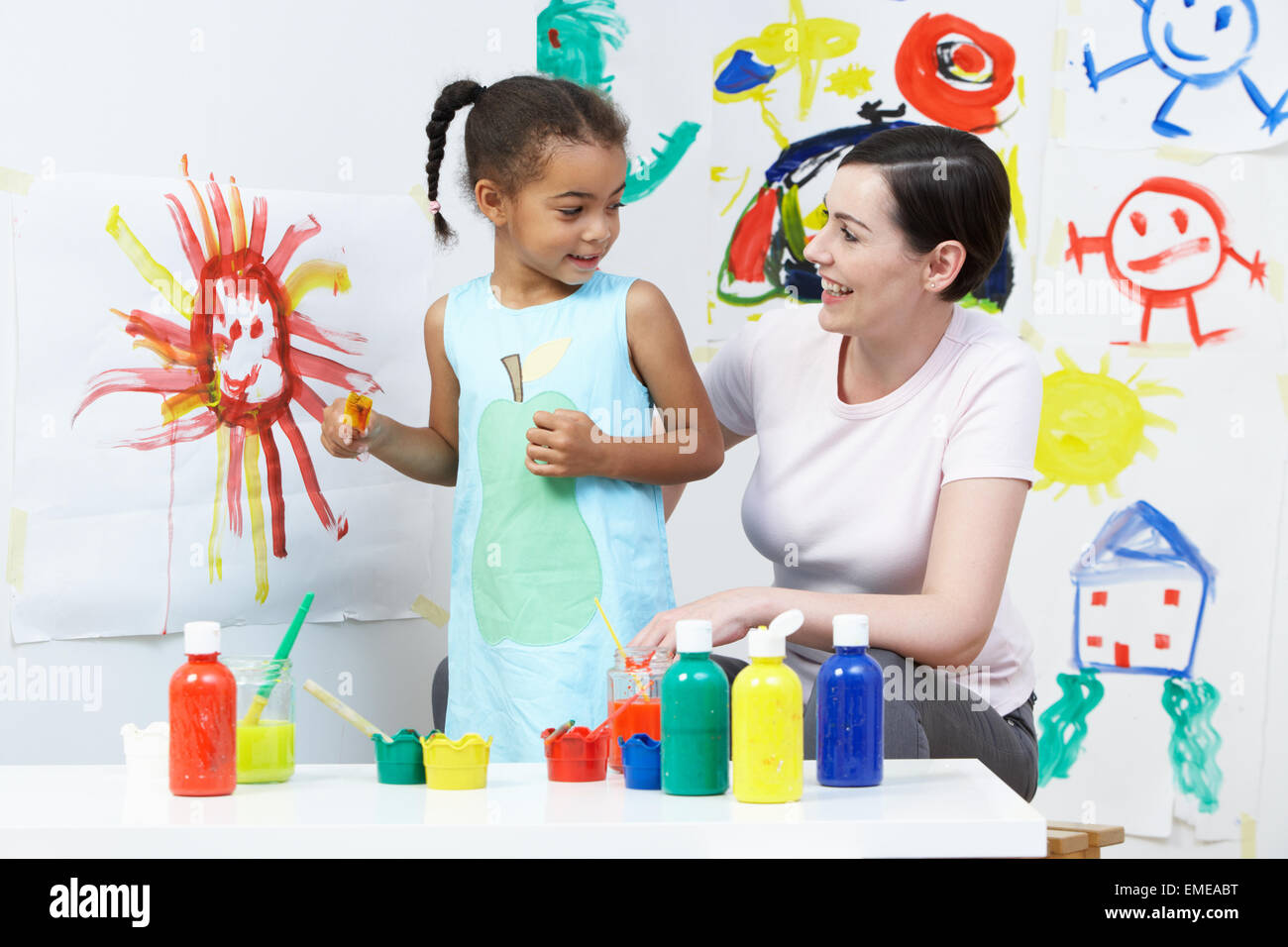 Teacher And Pupil In Pre School Art Class Stock Photo Alamy