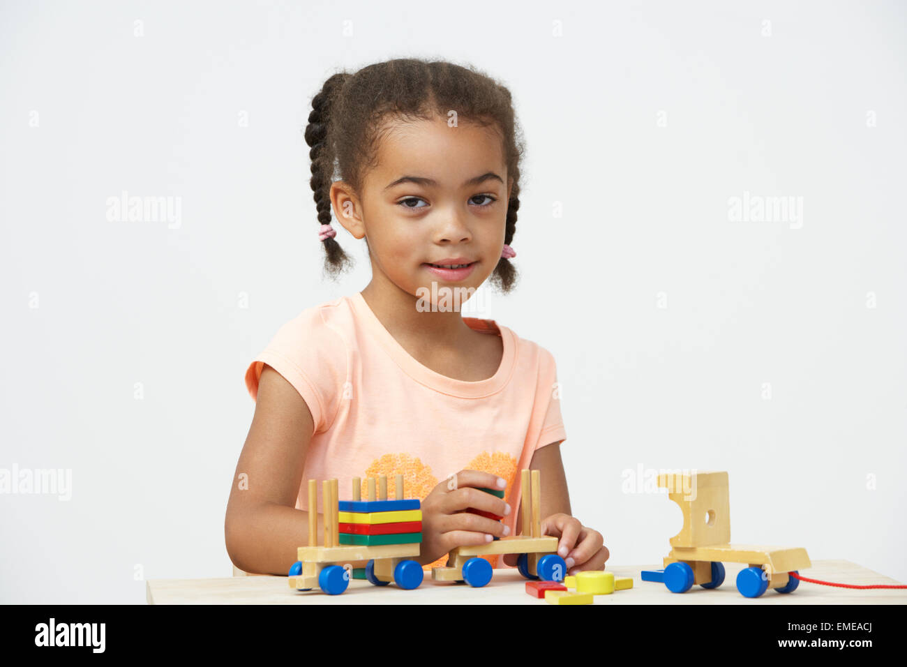 Pre-School Pupil Playing With Wooden Toy Train Stock Photo