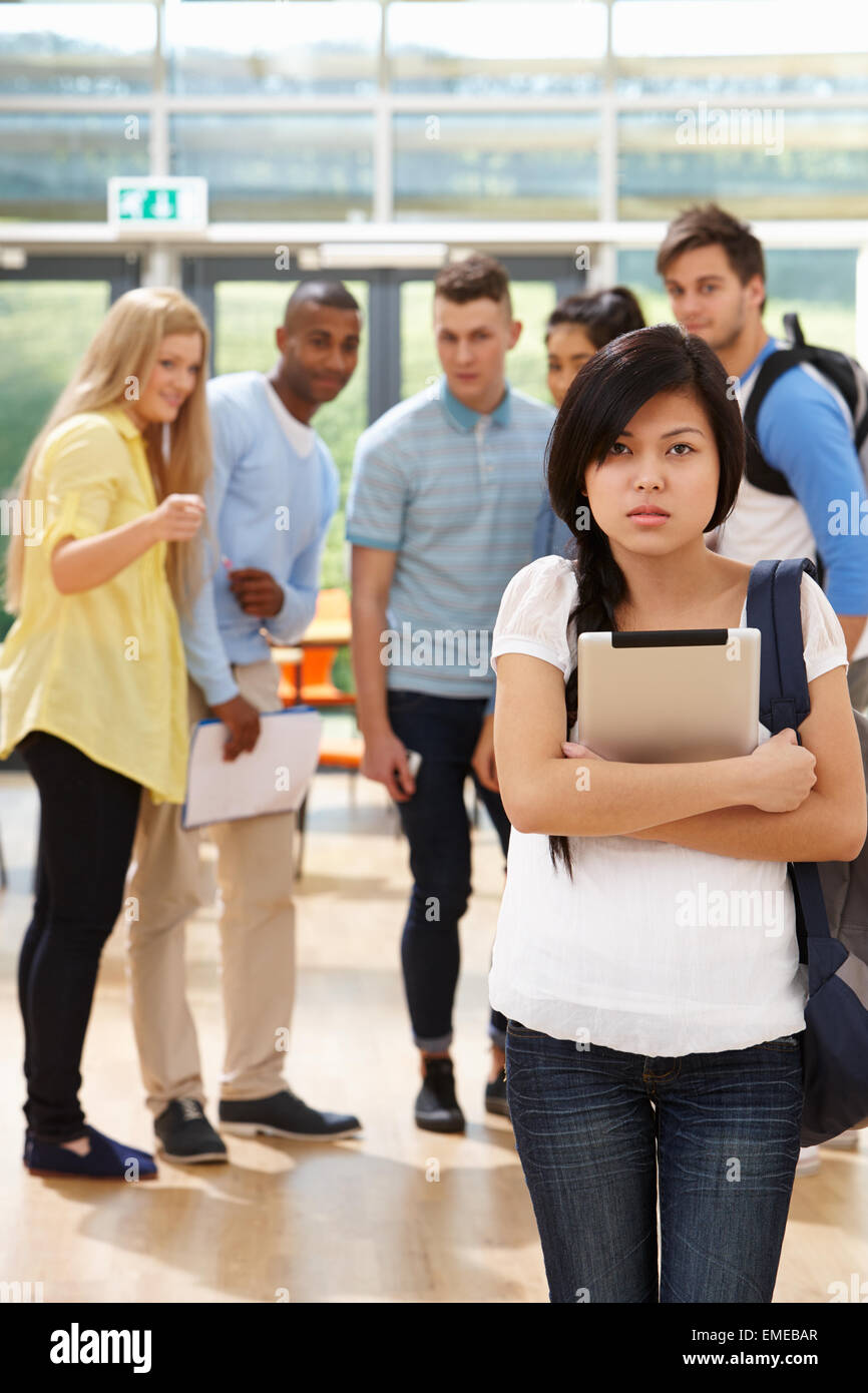 Female Student Being Bullied By Classmates Stock Photo