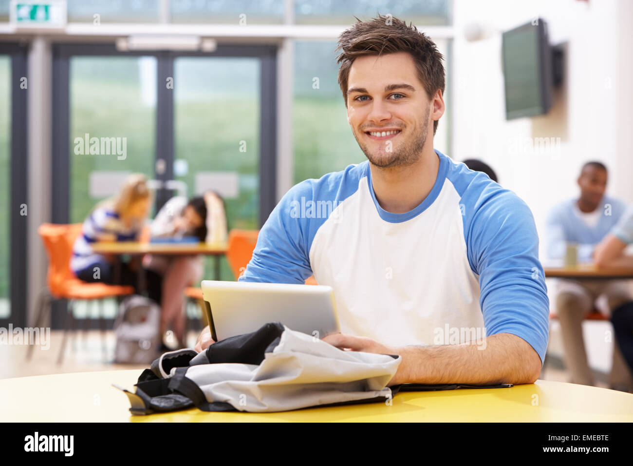 Male Student Studying In Classroom With Digital Tablet Stock Photo