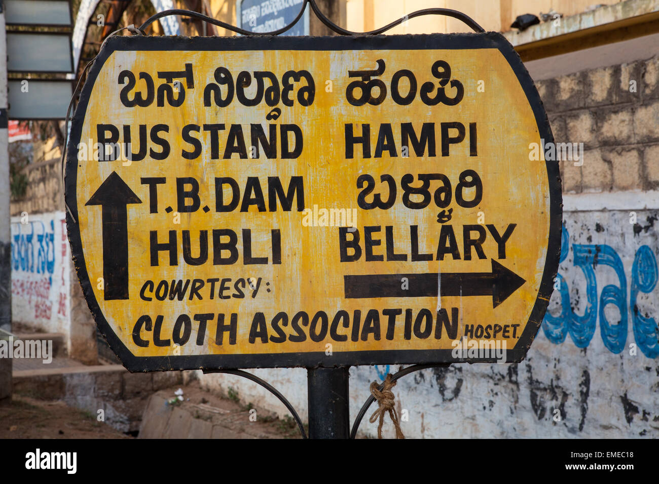 Road sign for directions to the bus stand and Hampi in Hospet Stock