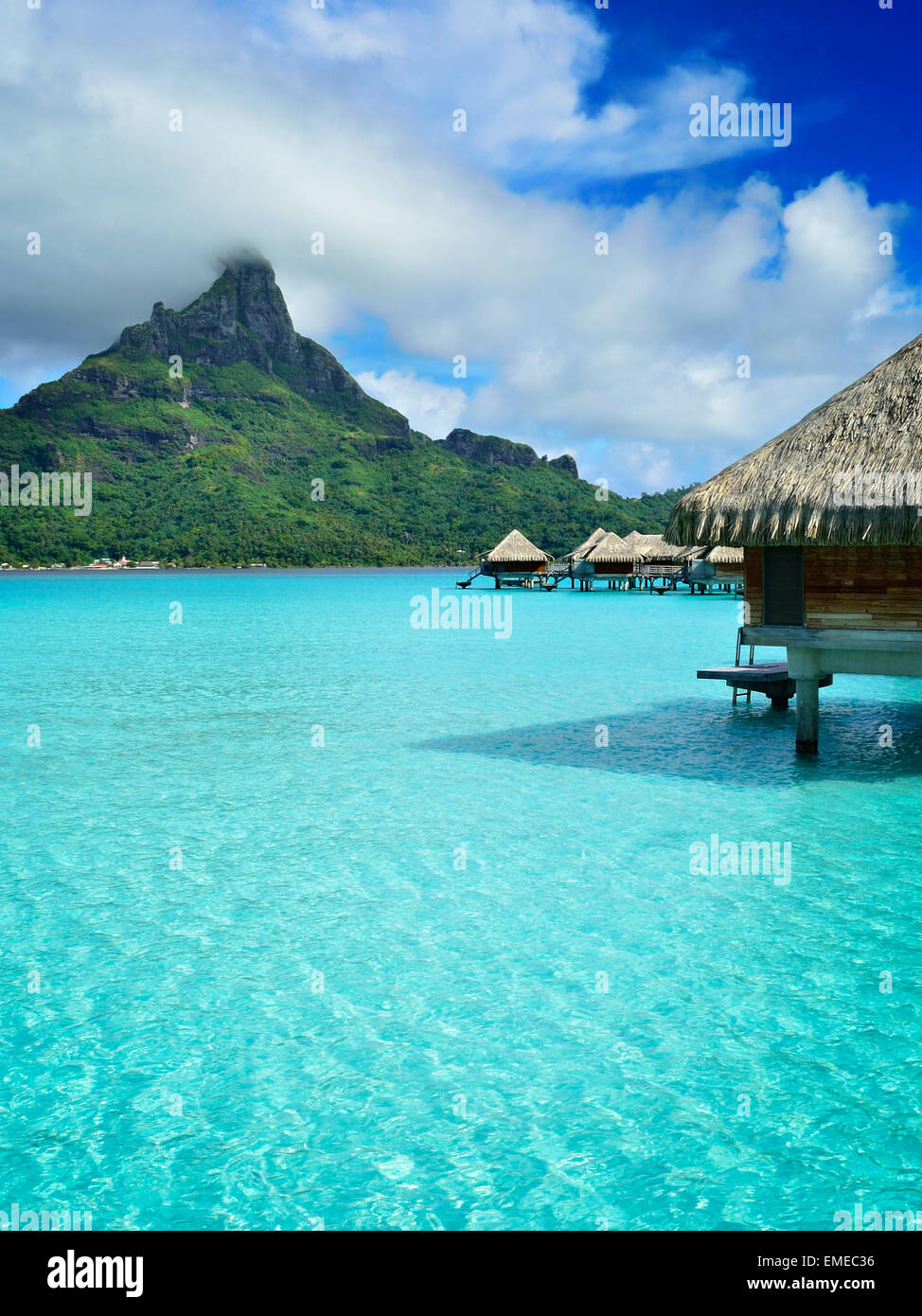 Luxury overwater honeymoon bungalows in a vacation resort in the clear blue lagoon of Bora Bora, French Polynesia Stock Photo