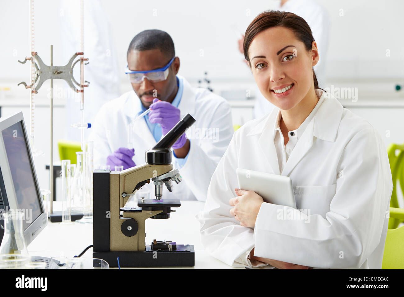 Technicians Carrying Out Research In Laboratory Stock Photo