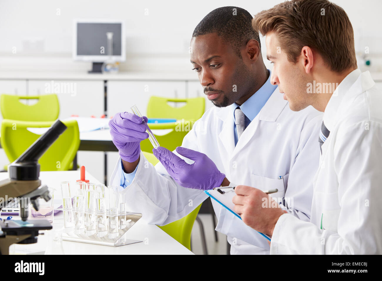 Two Technicians Working In Laboratory Stock Photo