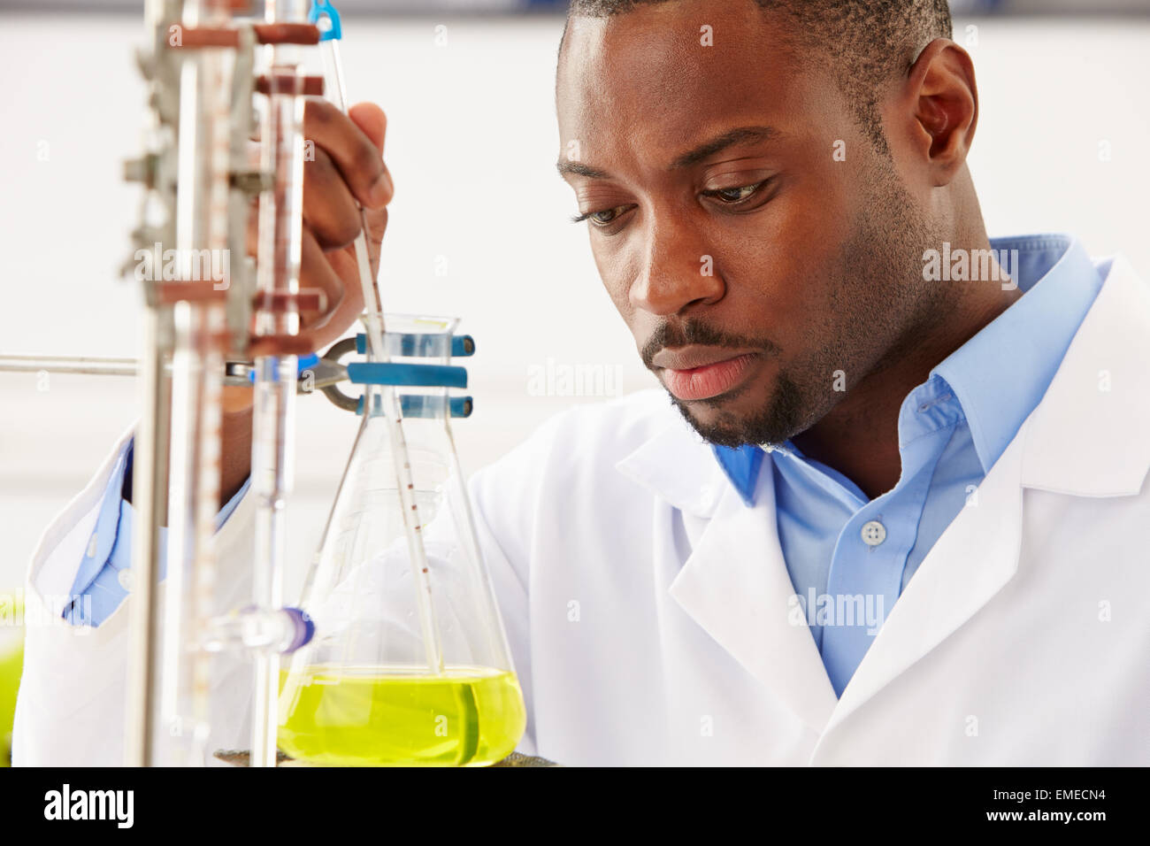 Scientist Studying Liquid In Flask Stock Photo