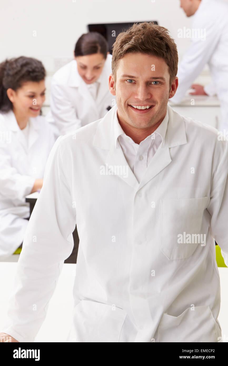 Portrait Of Technician In Laboratory With Colleagues Stock Photo