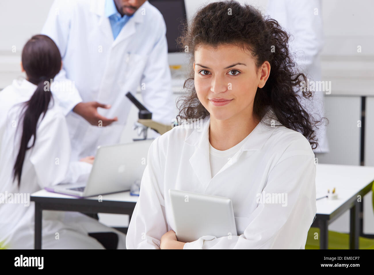 Portrait Of Technician In Laboratory With Colleagues Stock Photo