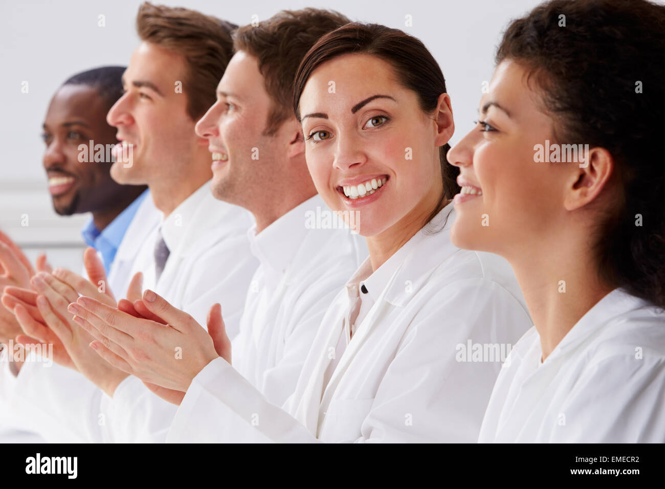 Portrait Of Technician And Colleagues In Laboratory Clapping Stock Photo