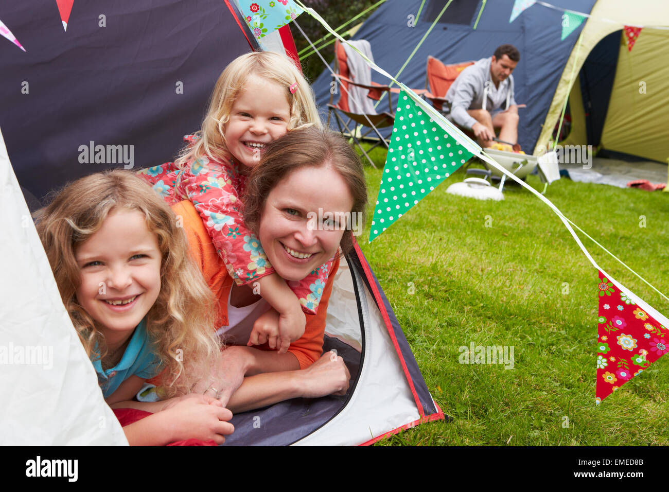 Family Enjoying Camping Holiday On Campsite Stock Photo