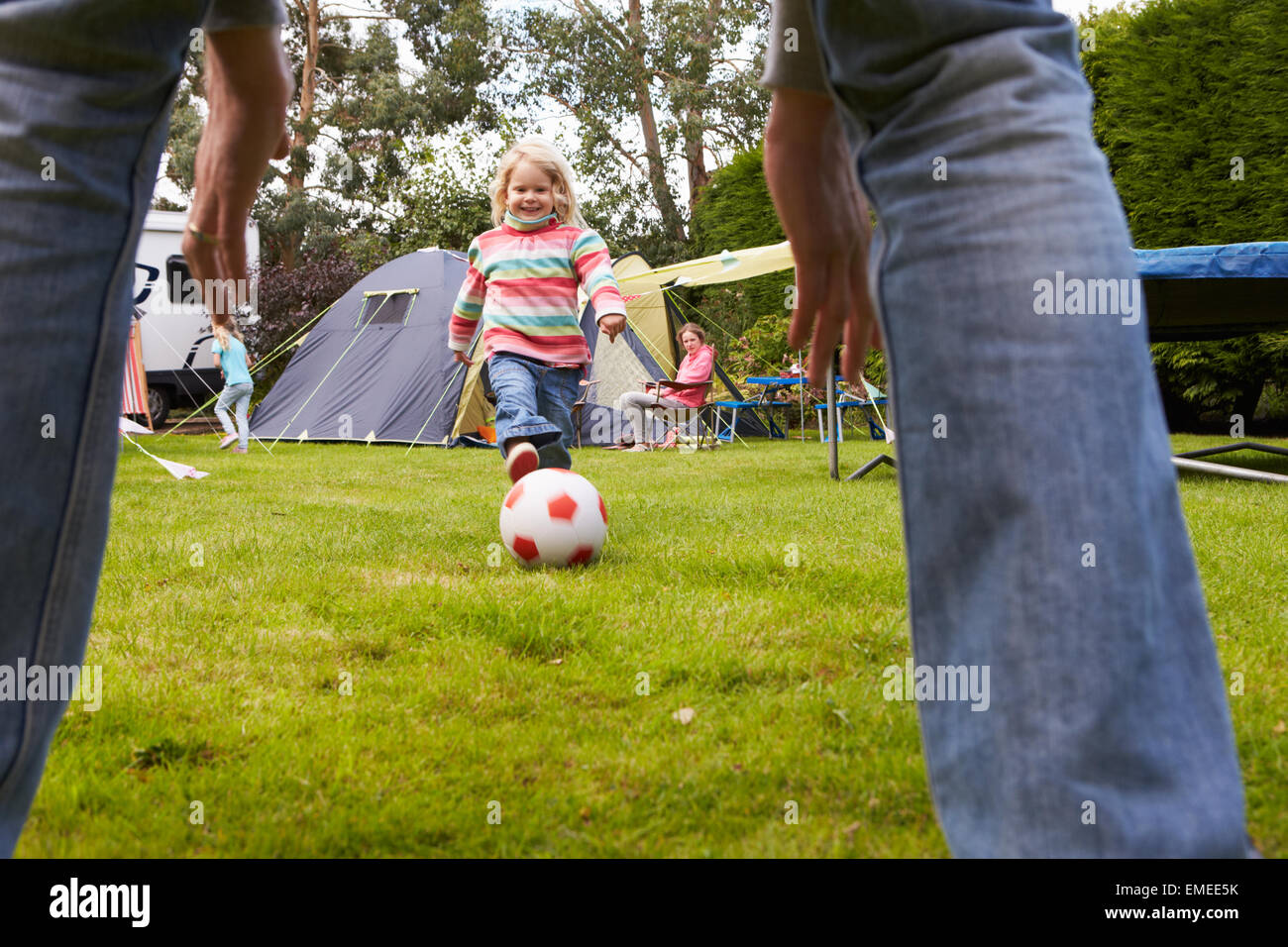 Family Having Football Match On Camping Holiday Stock Photo