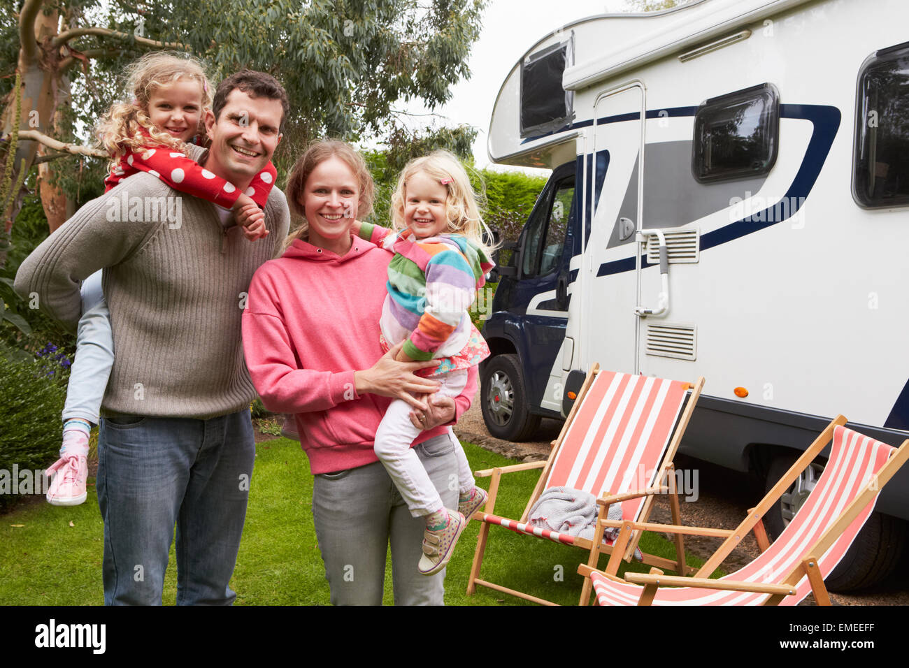 Portrait Of Family Enjoying Camping Holiday In Camper Van Stock Photo