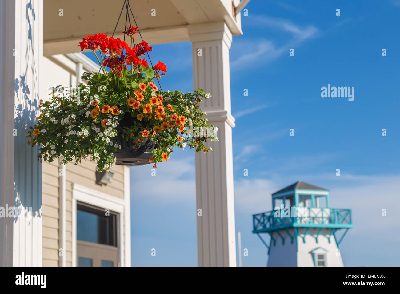 Hanging basket with lighthouse in the background in Summerside, Prince Edward Island, Canada. Stock Photo
