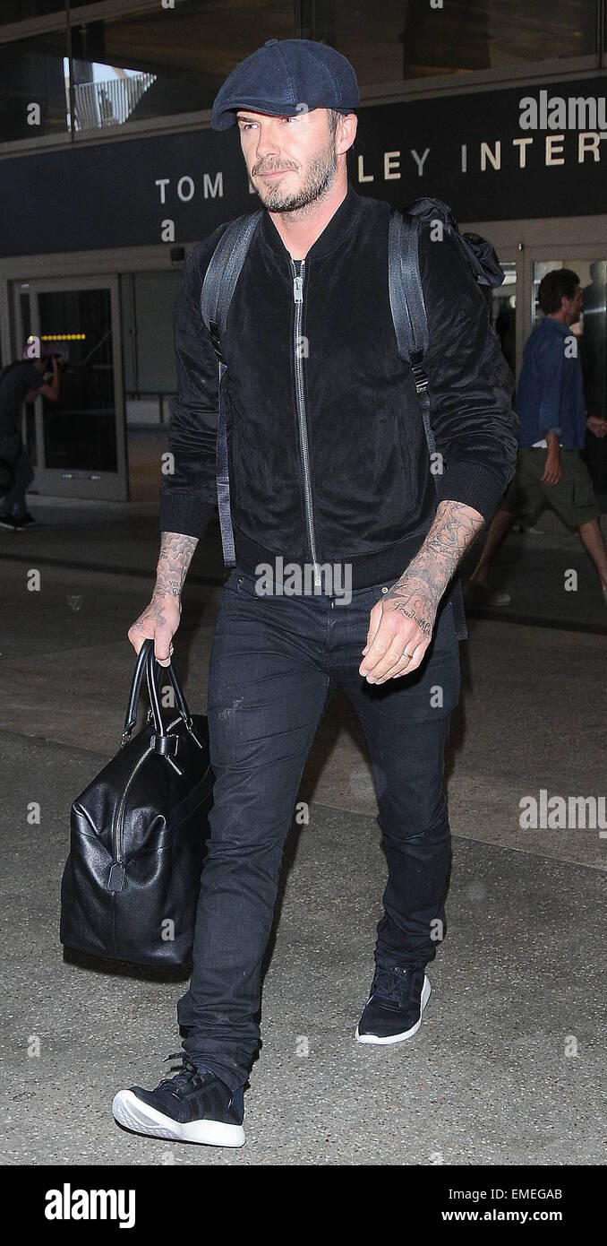 David Beckham arrives at Los Angeles International Airport wearing a flat cap, black bomber