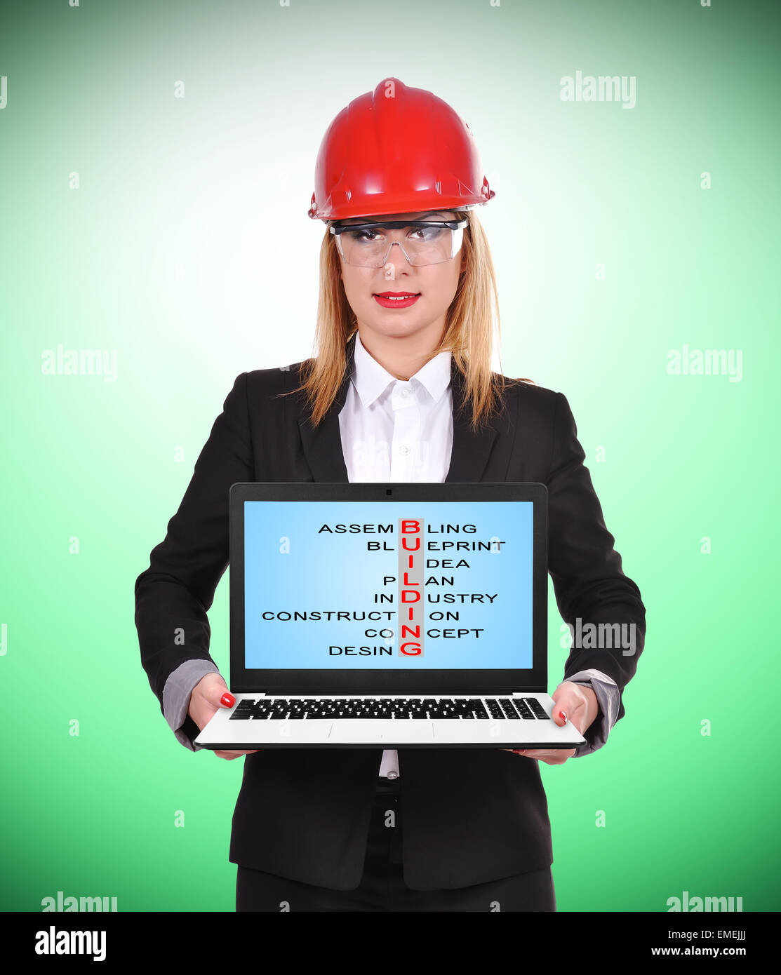 woman engineer holding pc with  crossword on construction Stock Photo