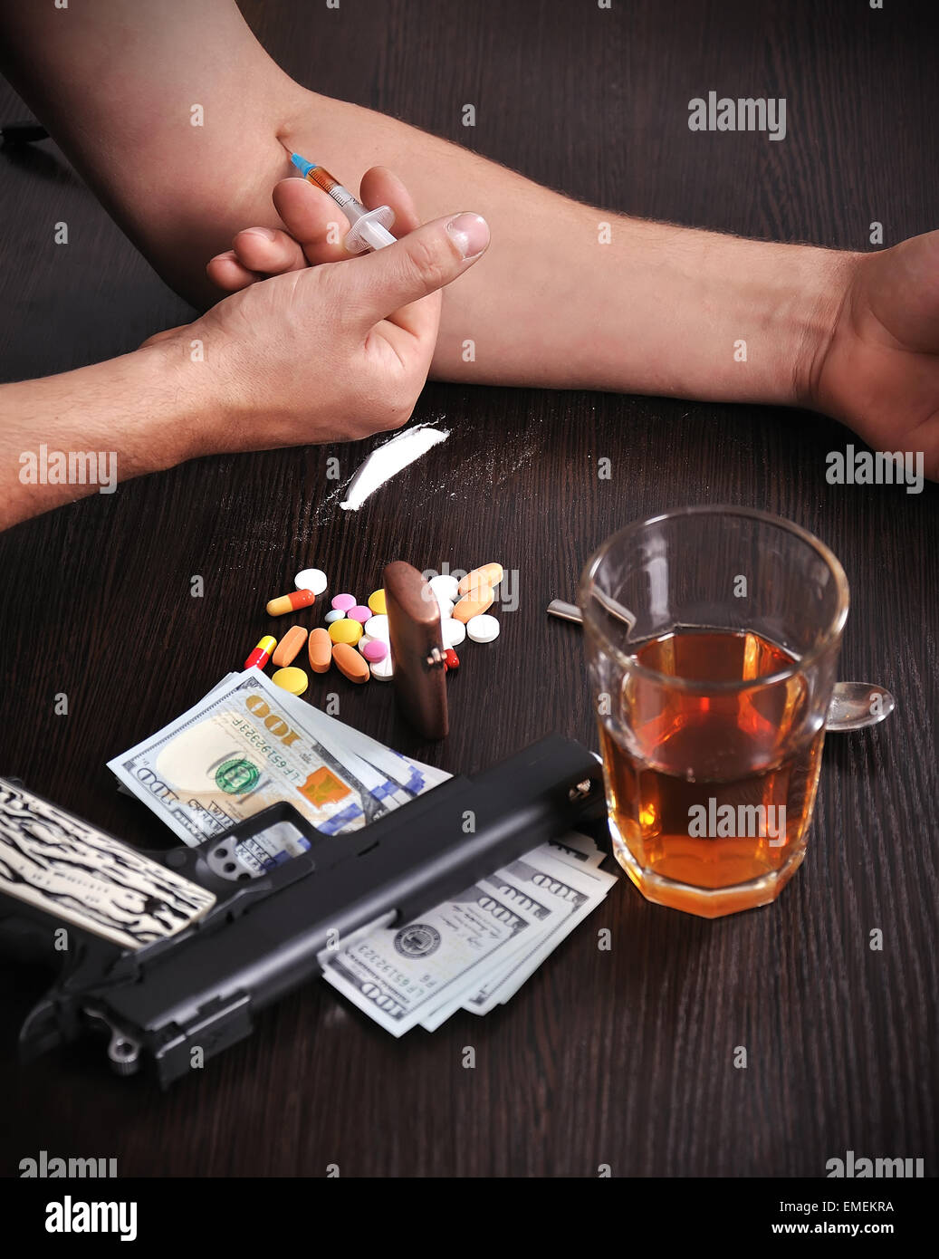 Drug addict man with syringe in action Stock Photo