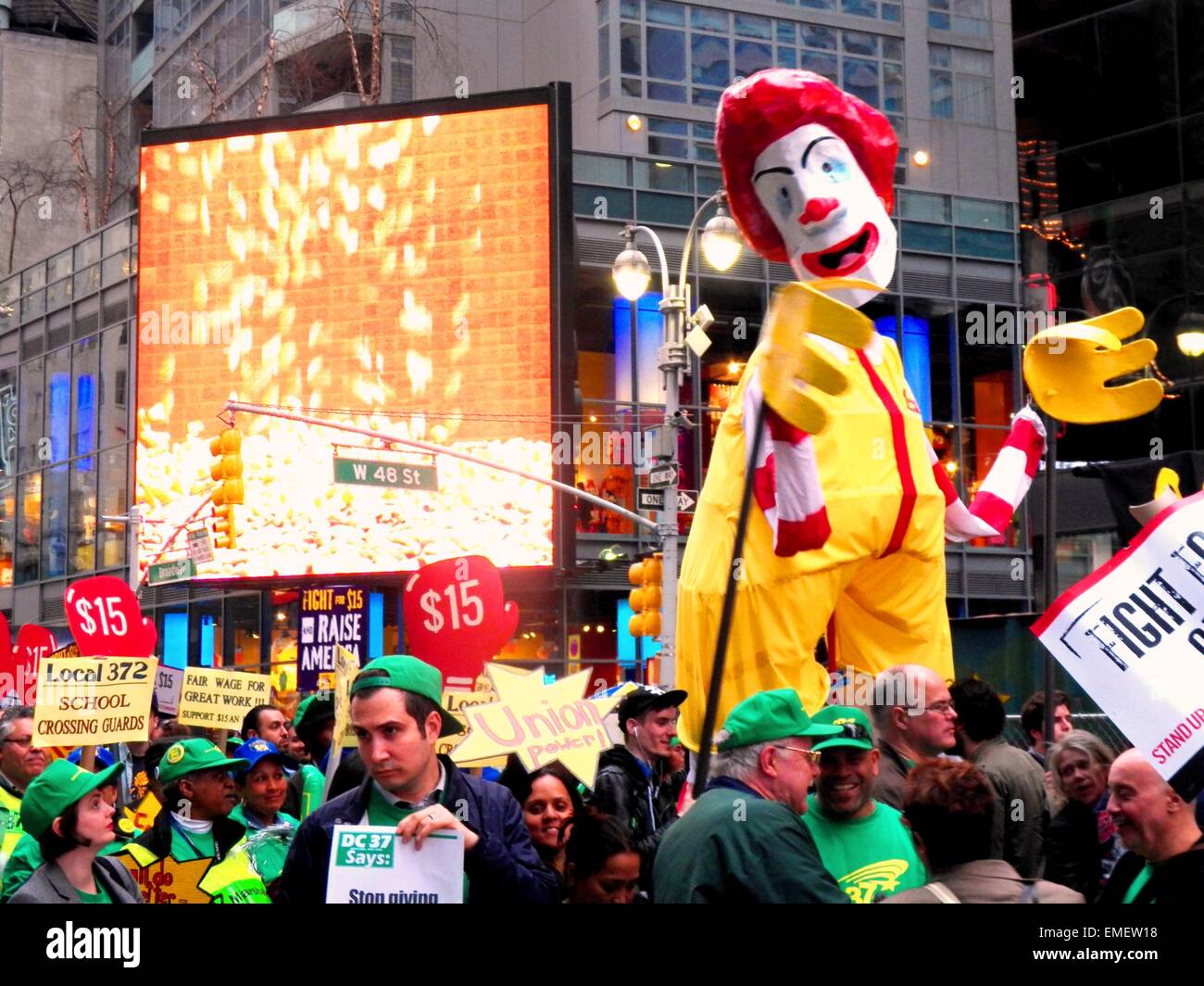 New York, United States. 15th Apr, 2015. A giant sized Ronald McDonald puppet is carried in the march, to represent the going fast food workers fight for a $15 and hour living wage. Thousands of people took part in the rally and march, community groups, unions, workers, students all calling for a $15 Dollar minimum wage in New York and across the Nation. © Mark Apollo/Pacific Press/Alamy Live News Stock Photo