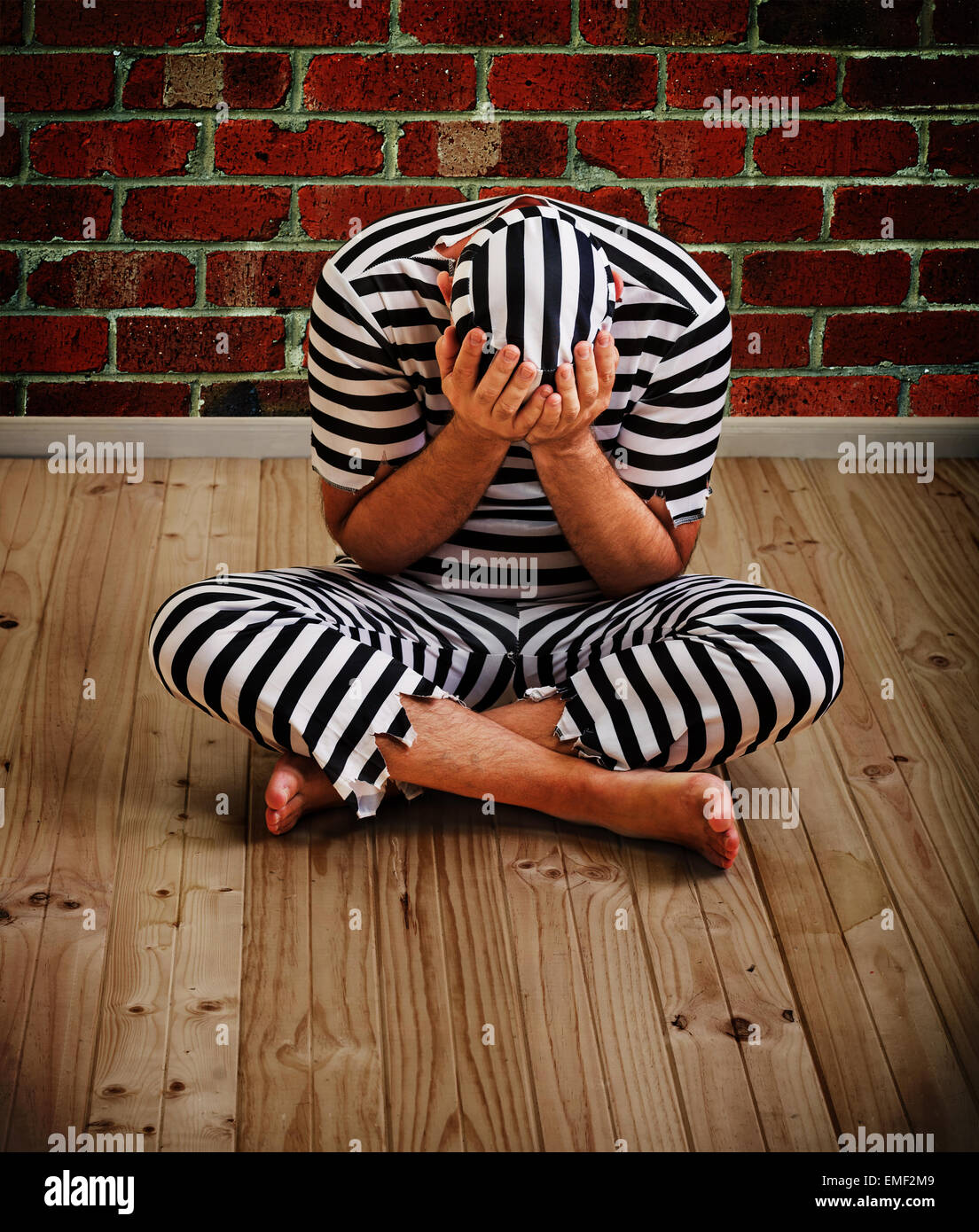 portrait of a repentant man prisoner in prison uniform Stock Photo