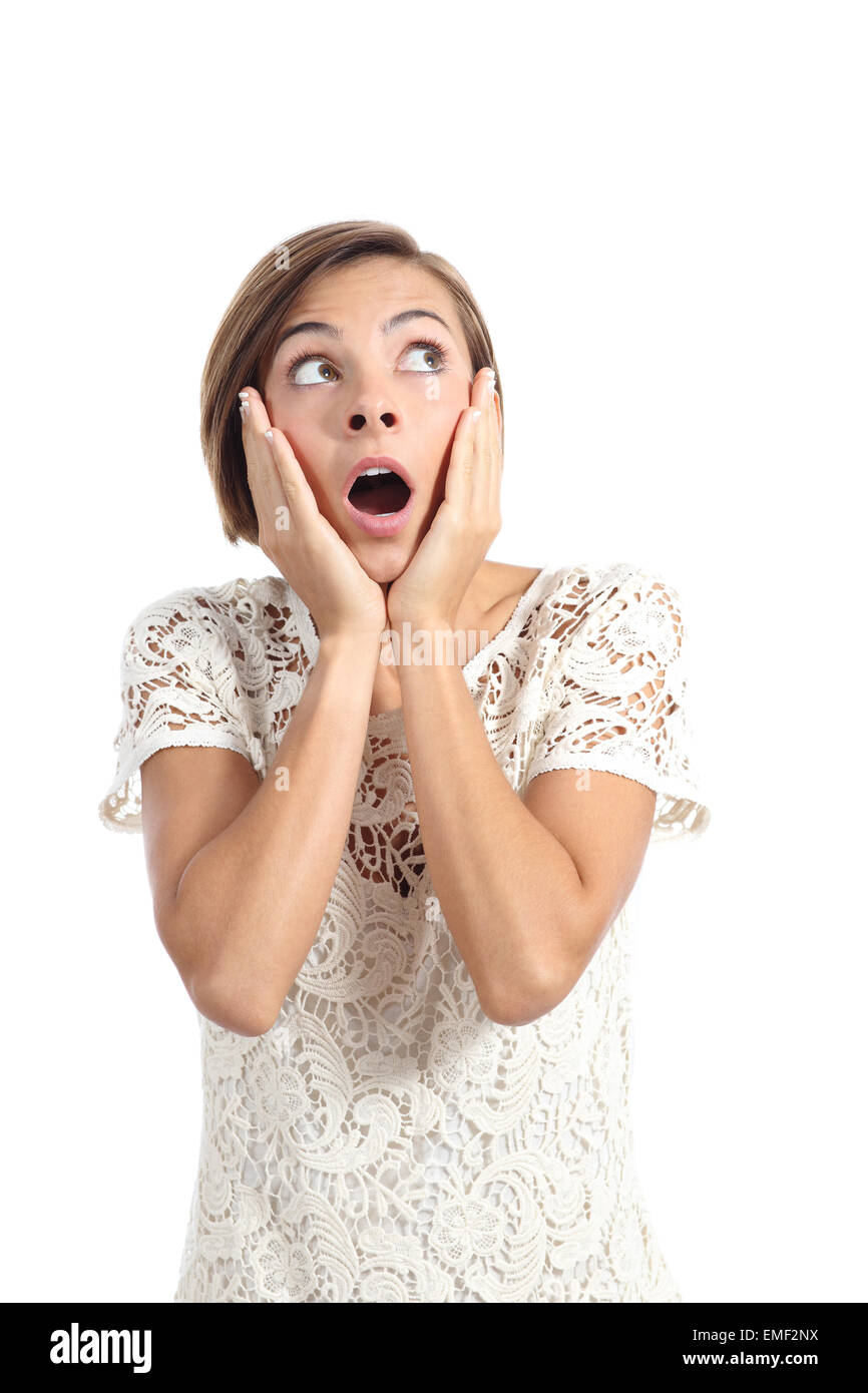 Shocked woman looking at side with hands on face isolated on a white background Stock Photo