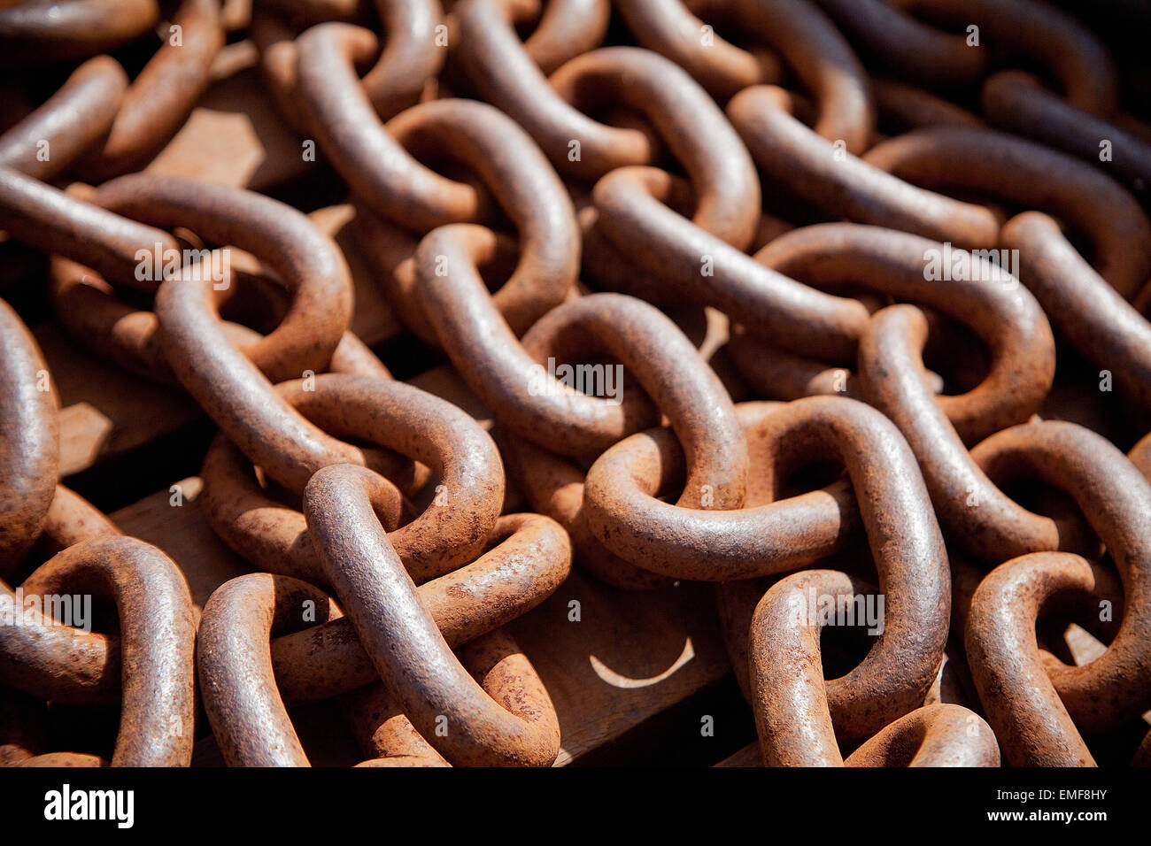 Old rusty chains on a pile Stock Photo