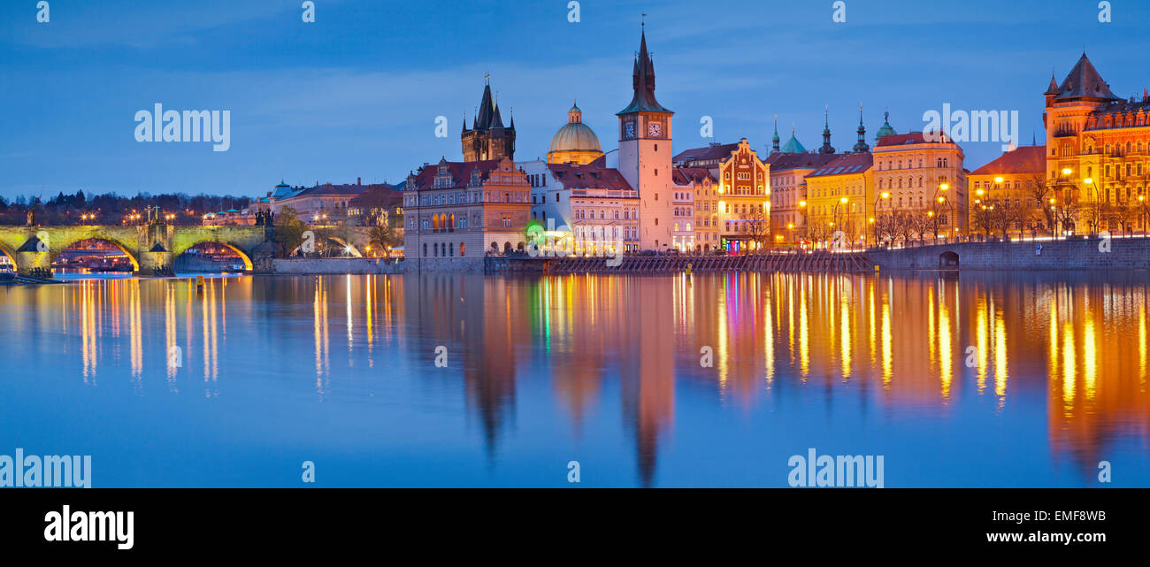 Prague Panorama. Panoramic image of Prague riverside and Charles Bridge, with reflection of the city in Vltava River. Stock Photo