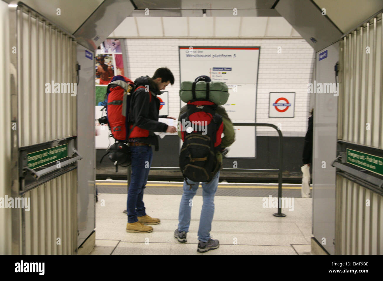 Backpackers on platform waiting for tube, at  London Underground Station,  England. Stock Photo
