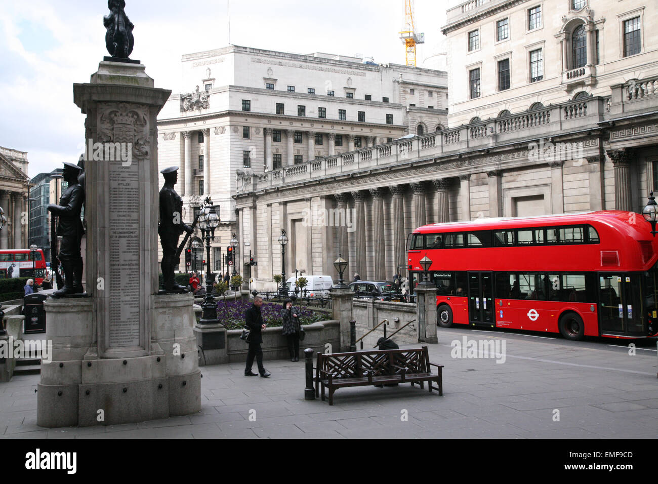New design London Transport Bus at World War Memorial Statue, The Royal Exchange, with bus and commuters, London England. Stock Photo