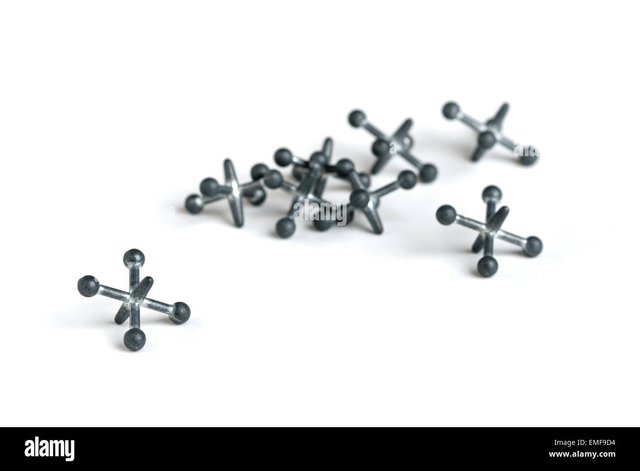 A set of metal jacks isolated against a white background. Stock Photo