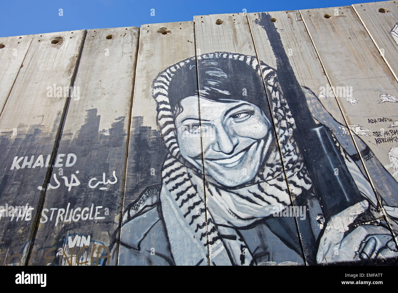 BETHLEHEM, ISRAEL - MARCH 6, 2015: The Detail of graffitti on the Separation barrier. Palestinian woman with the weapon. Stock Photo