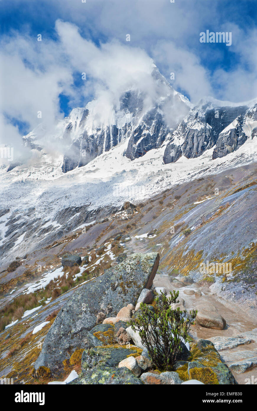 Peru - Tawllirahu peak (hispanicized spelling Taulliraju - 5,830) in Cordillera Blanca in the Andes from the trek of santa Cruz. Stock Photo