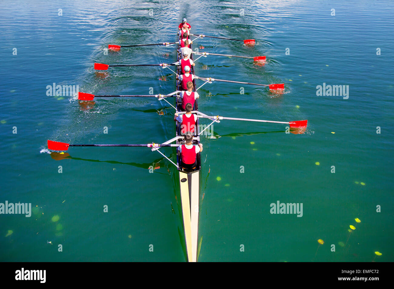 Boat coxed eight Rowers rowing on the blue lake Stock Photo Alamy