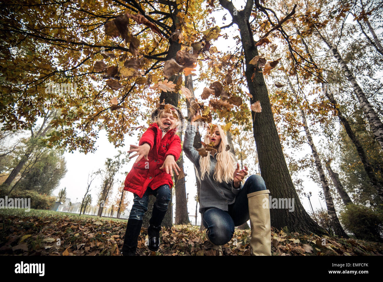 mother and daughter having fun in autumn park Stock Photo - Alamy