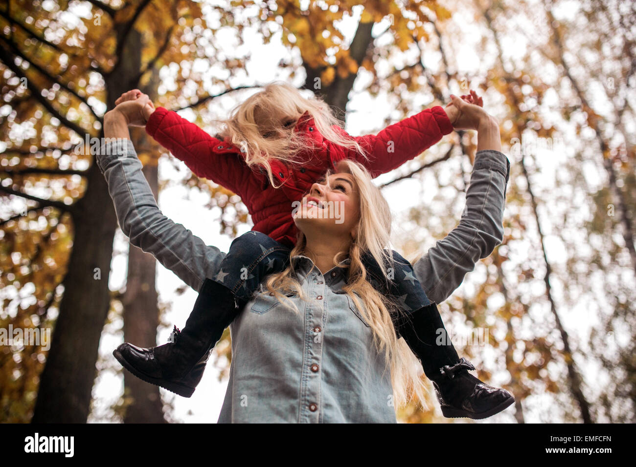 mother and daughter having fun in autumn park Stock Photo - Alamy