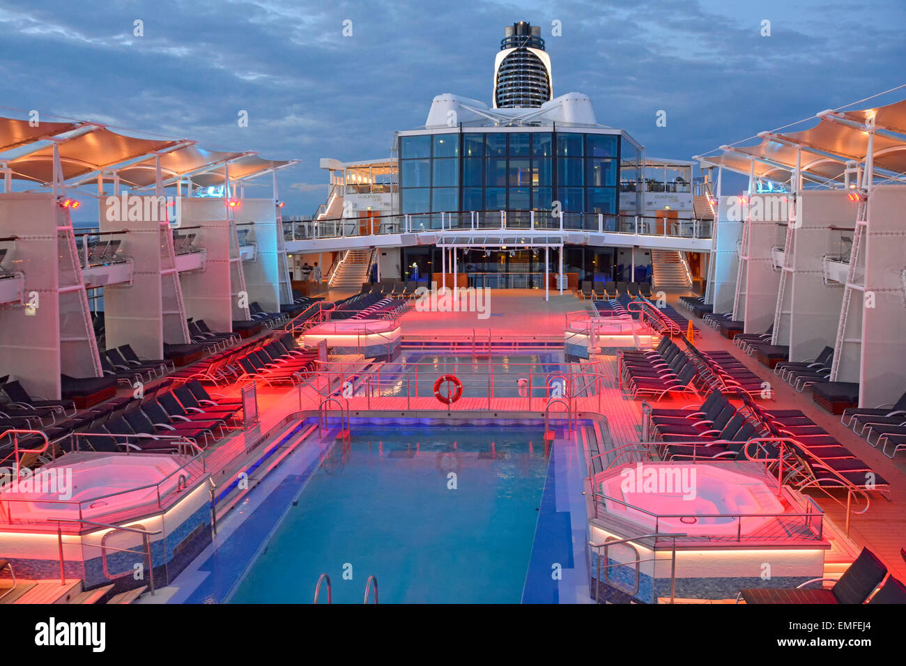 Flood lighting on cruise ship pool deck at end of day with passengers below decks for evening meal (for daytime view see Alamy Additional info panel) Stock Photo