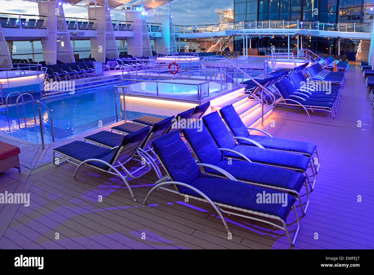 Blue night lighting on cruise ship pool deck at end of day with