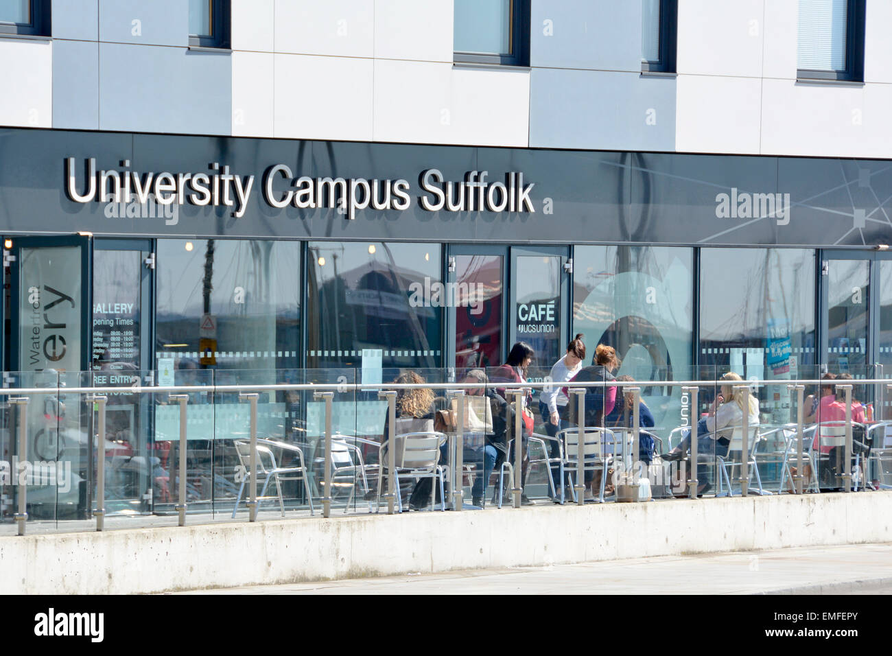 Students and visitors at University Campus Suffolk outdoor waterfront café tables and entrance to Gallery Ipswich England UK Stock Photo