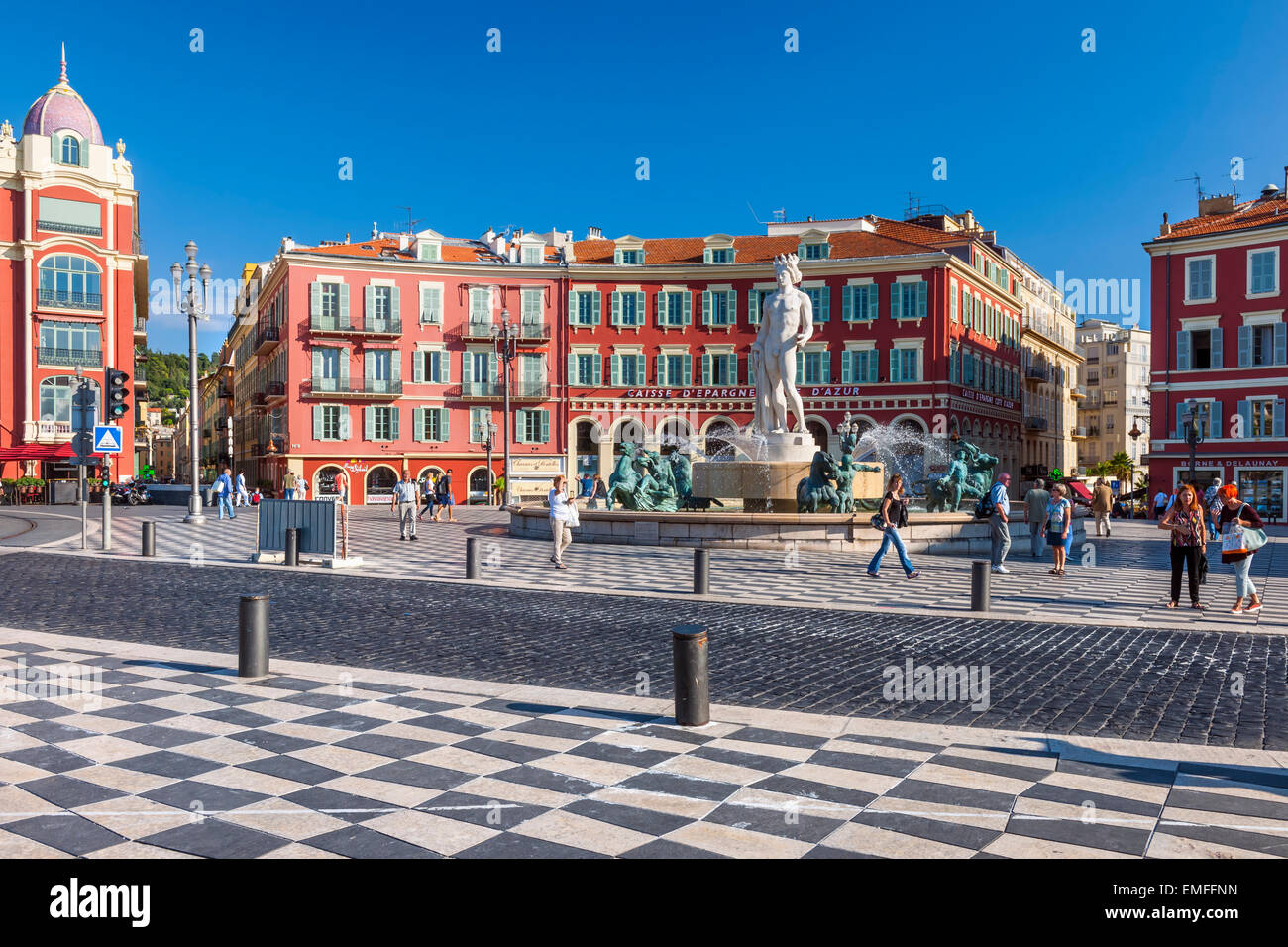 NICE, FRANCE - OCTOBER 2, 2014: View of Place Massena with Fountain of the Sun (Fontaine du Soleil) surrounded by red buildings Stock Photo