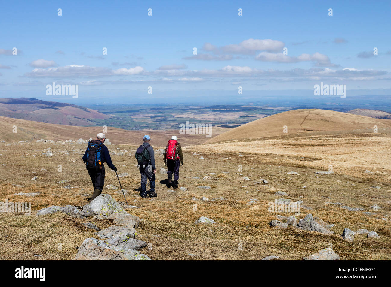 3 Walkers Leaving the Hill of White Stones and Walking North Towards Hartside Fell on a Sunny Spring Day Lake District Cumbria U Stock Photo