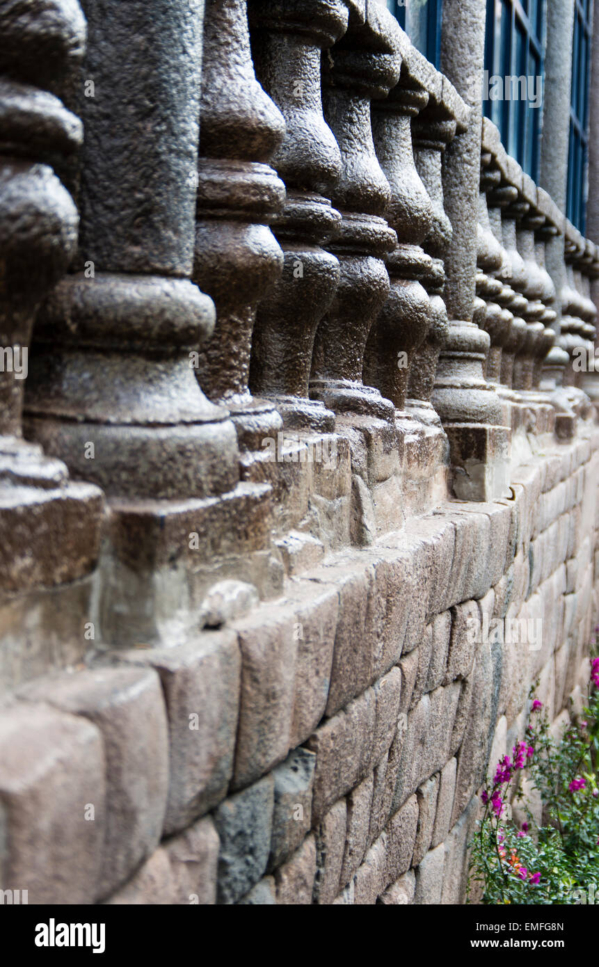 Spanish colonial architecture on a wall of Inca stone in Cusco, Peru. Stock Photo