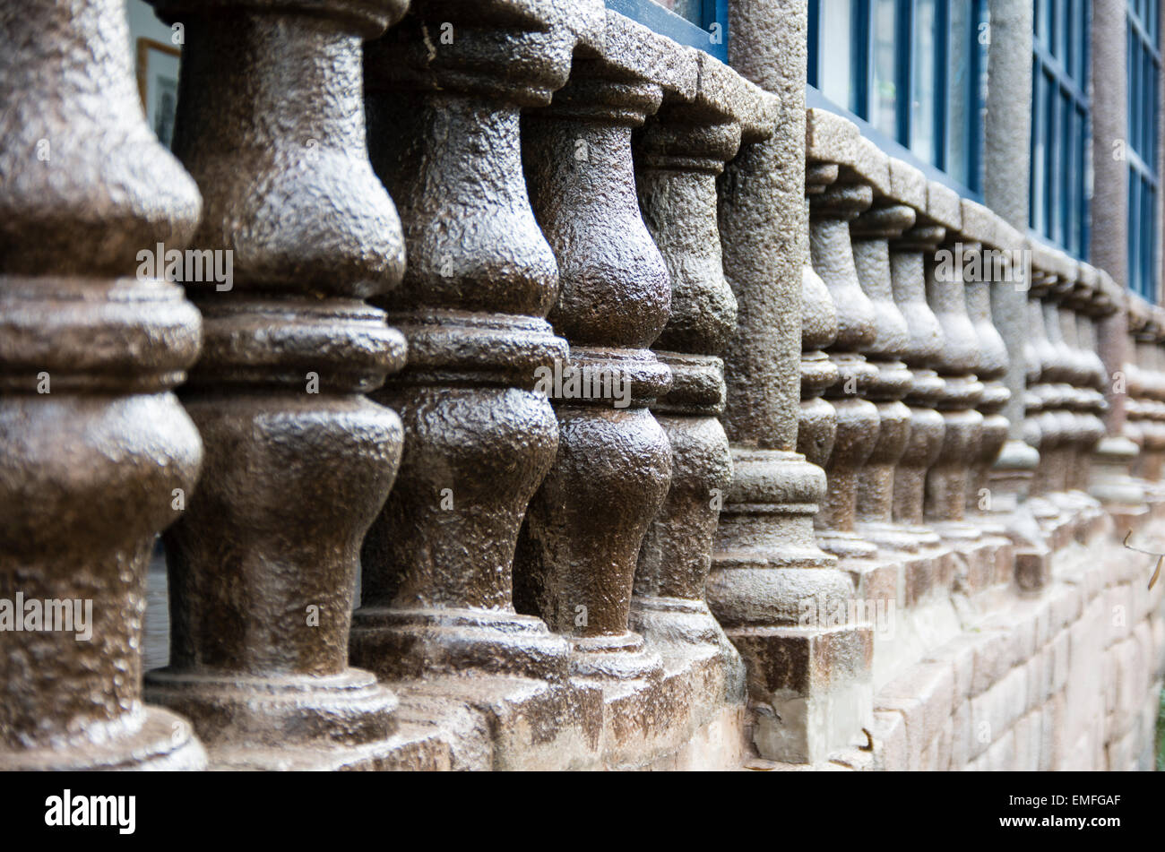 Spanish colonial architecture on a wall of Inca stone in Cusco, Peru. Stock Photo