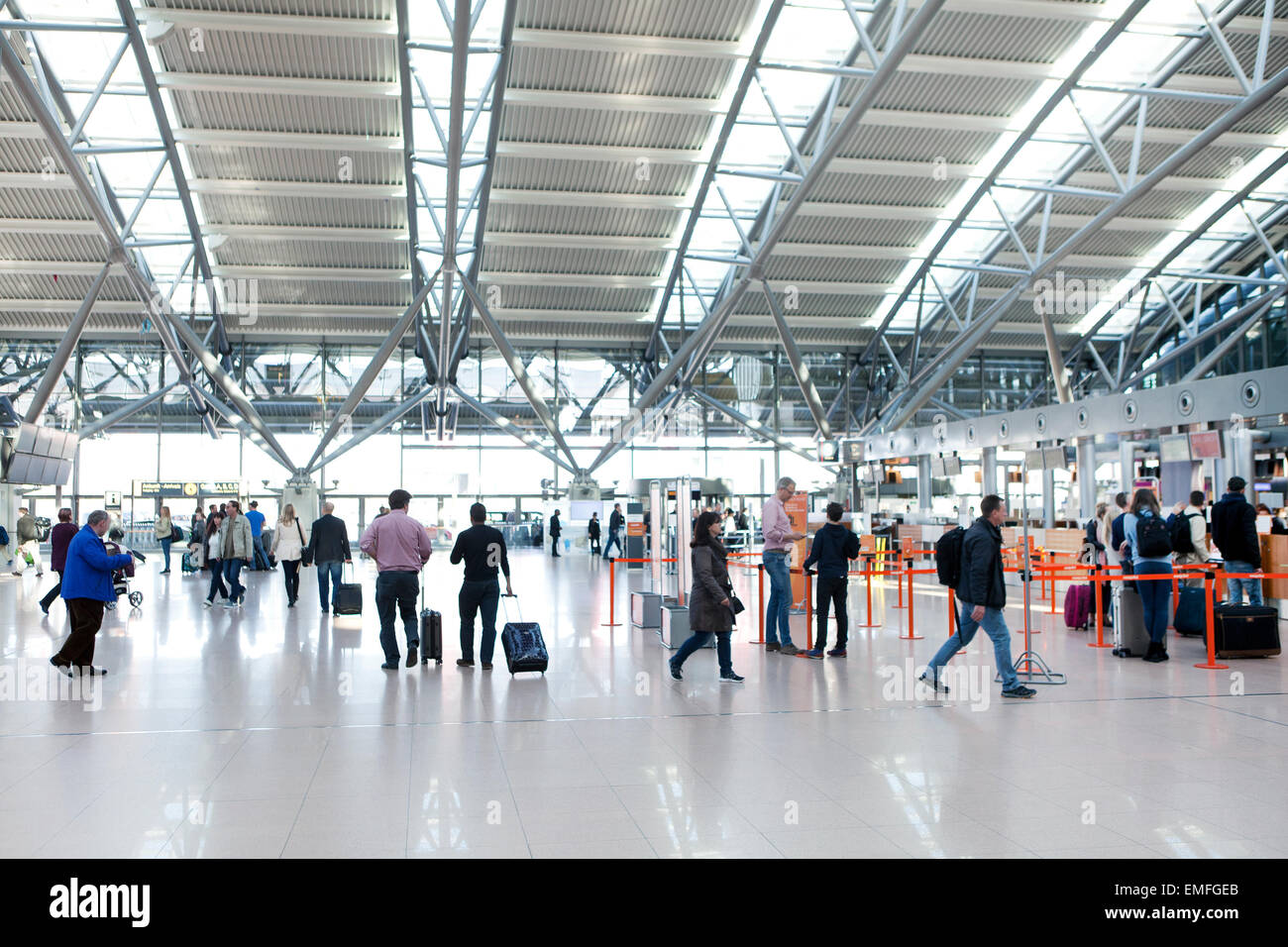 Tourists with suitcases at Hamburg airport check in area Stock Photo