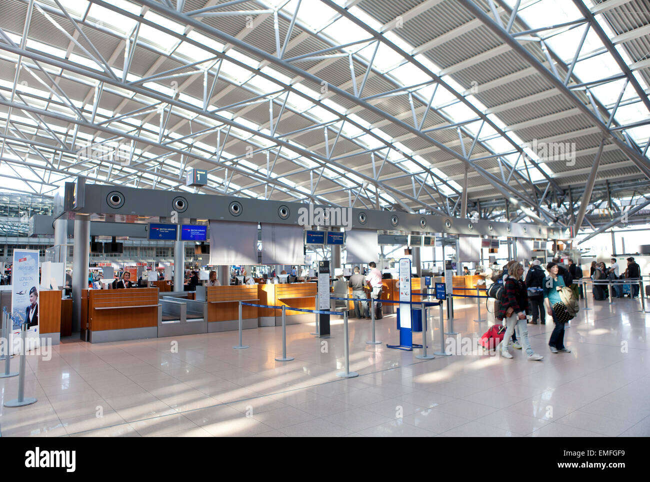 Tourists with suitcases at Hamburg airport check in area Stock Photo