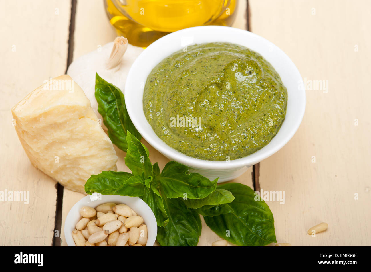 Italian traditional basil pesto sauce ingredients on a rustic table Stock Photo