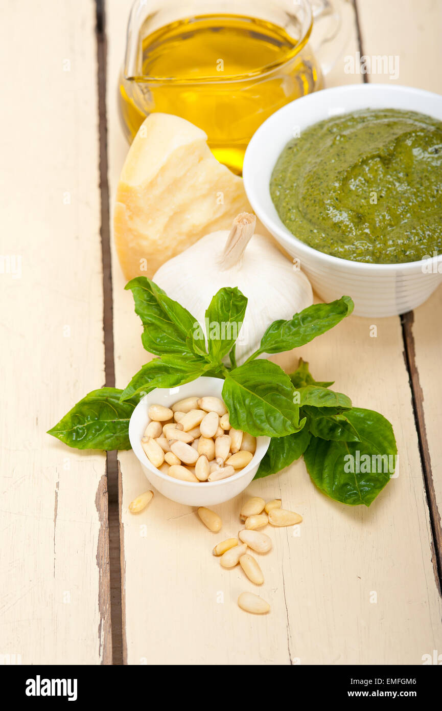 Italian traditional basil pesto sauce ingredients on a rustic table Stock Photo