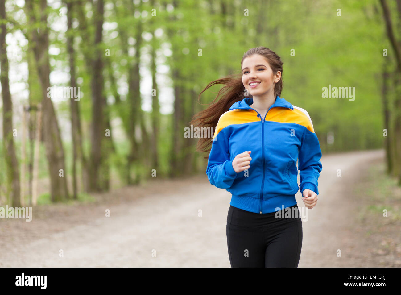 Young beautiful woman running on a trail Stock Photo - Alamy