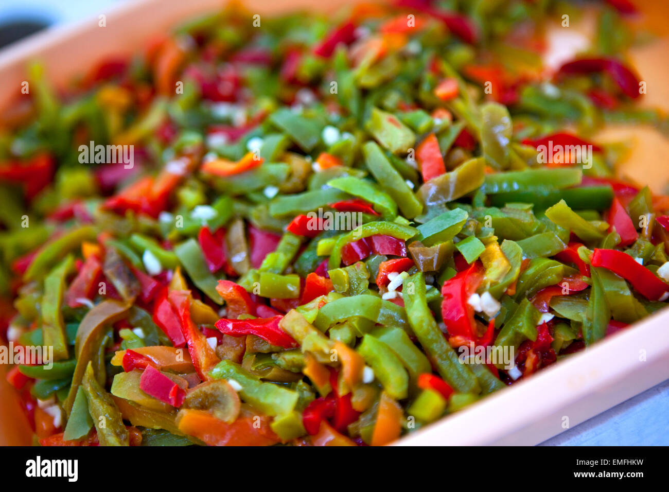 Red and green peppers cut in a dish Stock Photo - Alamy
