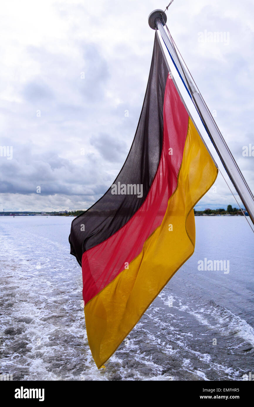 German flag at back of a boat in the wind Stock Photo