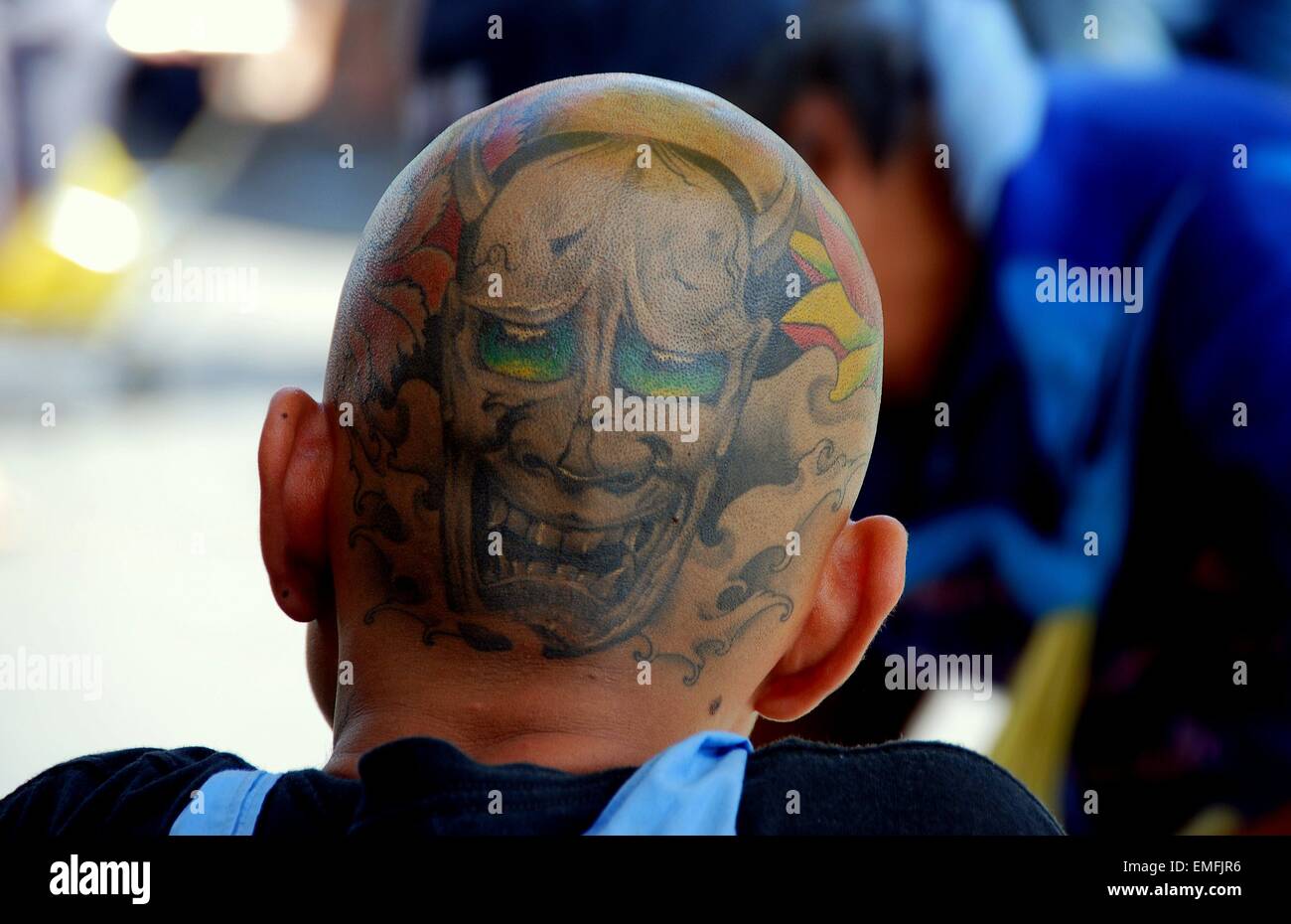 Bangkok, Thailand:   Thai youth with shaved head covered in tattoos at the Chatuchak weekend market  * Stock Photo